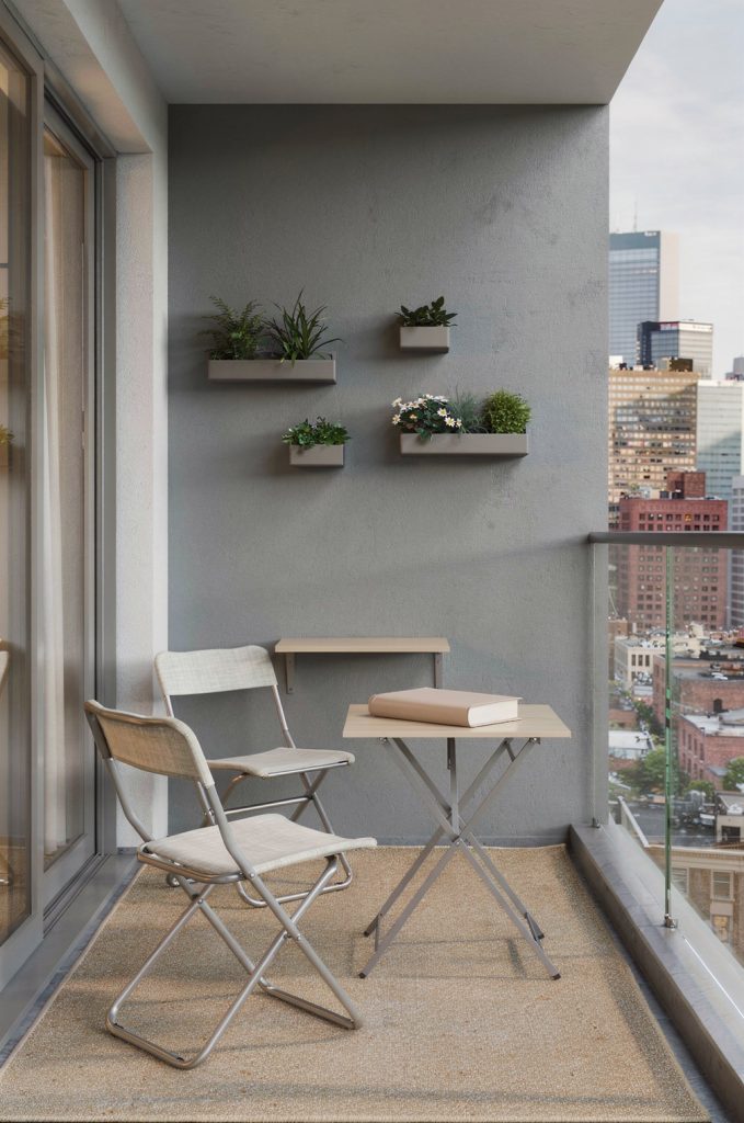 small balcony with foldable chairs, slim table and wall planters showing compact balcony furniture ideas