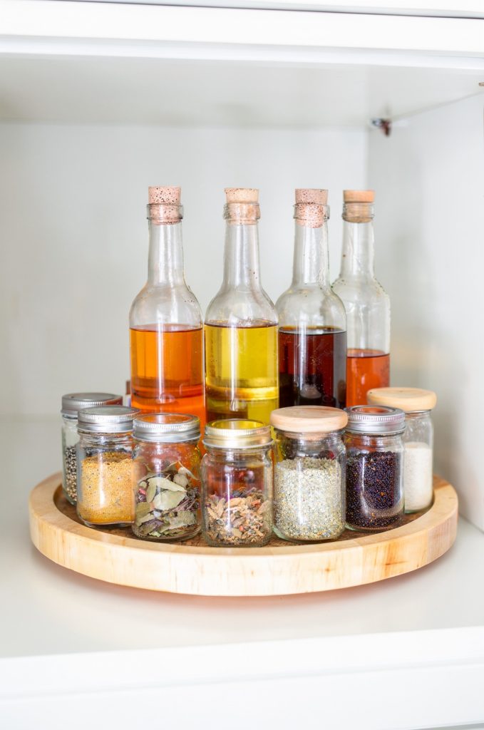 wall mounted rack with hanging frying pans in small kitchen