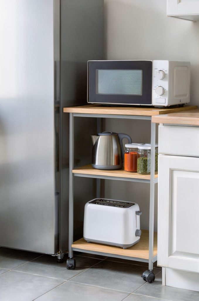 rolling kitchen cart used for extra storage in small kitchen