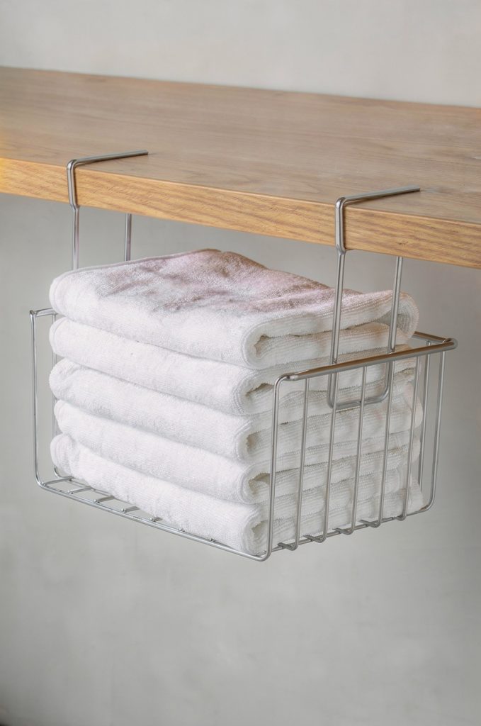 under shelf basket organizer holding folded kitchen towels