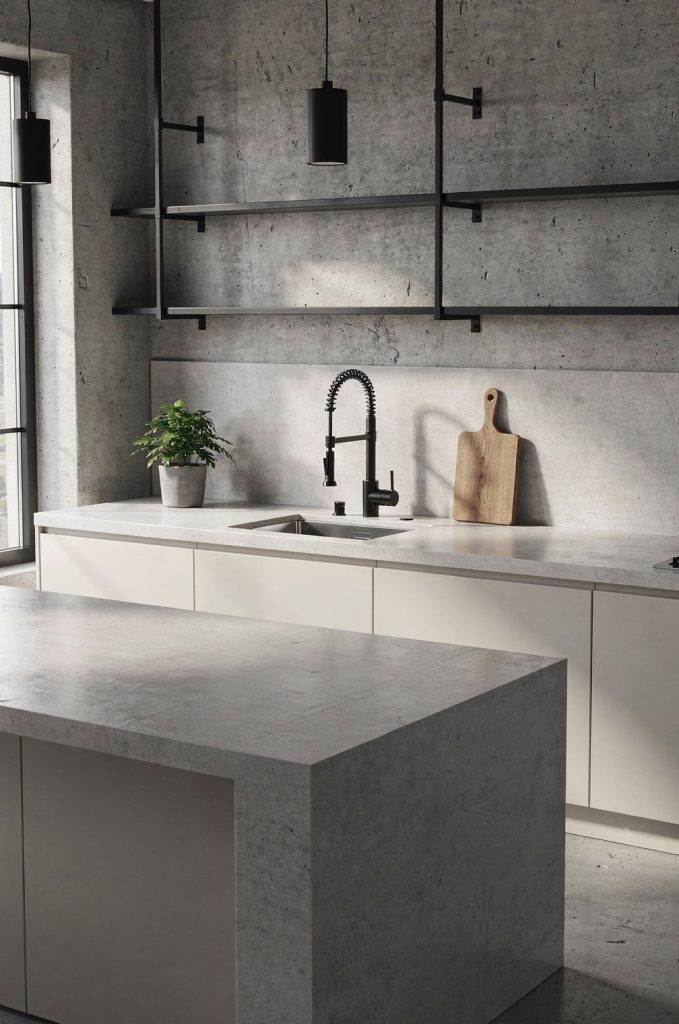 Minimal industrial kitchen with concrete island, black metal shelving, wall-mounted faucet, and neutral cabinetry.